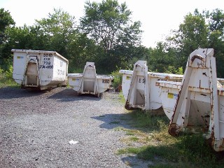 White rental dumpsters of various sizes